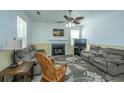 Inviting living room featuring a fireplace, plush sofas, and a ceiling fan at 226 Killarney Trl, Moncks Corner, SC 29461