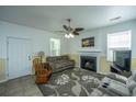 Cozy living room features a fireplace, ceiling fan, and comfortable seating at 226 Killarney Trl, Moncks Corner, SC 29461