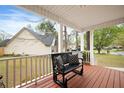 Cozy covered porch featuring bench seating and a view of the lush front yard at 234 Lipman St, Summerville, SC 29483