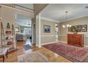 Spacious dining room featuring hardwood floors, elegant columns, and an open view to the living room at 2616 Magnolia Woods Dr, Mount Pleasant, SC 29464