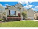 Beautiful two-story home with a manicured lawn, red front door, and attached two-car garage at 2616 Magnolia Woods Dr, Mount Pleasant, SC 29464