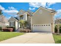 Charming two-story home with landscaped yard and a two-car garage on a sunny day at 2616 Magnolia Woods Dr, Mount Pleasant, SC 29464