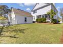Large grassy backyard with a detached garage and plenty of space for outdoor activities at 2681 Park West Blvd, Mount Pleasant, SC 29466