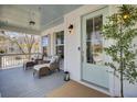 Relaxing front porch with comfortable seating, a blue ceiling, and a view of the charming neighborhood at 2681 Park West Blvd, Mount Pleasant, SC 29466