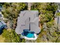 Birds eye view featuring private pool, sprawling roof, and lush tree coverage at 27 Waterway Island Dr, Isle of Palms, SC 29451