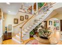 Grand foyer with hardwood floors, a sweeping staircase, and elegant decor throughout at 27 Waterway Island Dr, Isle of Palms, SC 29451