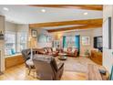 Cozy living room with wood beams, hardwood floors, and comfortable leather seating at 28 Rebellion Rd, Charleston, SC 29407