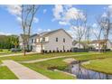 Beautiful home showcasing a well-kept lawn, a flowing creek, and scenic neighborhood views at 2830 Backman St, Mount Pleasant, SC 29466