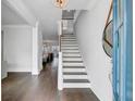 Bright foyer featuring wood floors, an elegant staircase, and a view into the adjacent living spaces at 2830 Backman St, Mount Pleasant, SC 29466