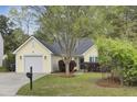 Charming single-story home with a well-manicured lawn, attached garage, and mature trees offering shade at 304 Arbor Oaks Dr, Summerville, SC 29485