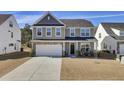 Charming two-story home with a two-car garage and meticulous landscaping at 307 Blue Oak Dr, Moncks Corner, SC 29461