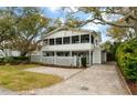 Charming two-story home with a screened porch, white picket fence, and a well-maintained yard at 3405 Cameron Blvd, Isle of Palms, SC 29451