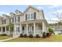 Inviting two-story house featuring a cozy front porch and well-maintained landscaping at 3443 Yarmouth Dr, Mount Pleasant, SC 29466