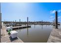 Picturesque marina view with wooden docks, calm waters, and boats under a clear blue sky at 3701 Dock Site Rd # 302, Edisto Beach, SC 29438