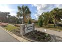 Evanston Estates community entrance sign with lush landscaping, mature palm trees and beautiful stone details at 4322 Bream Rd, North Charleston, SC 29418