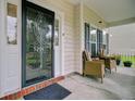 Cozy front porch featuring seating area with wicker chairs and an ornate glass door at 5254 Mulholland Dr, Summerville, SC 29485