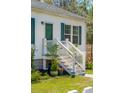 Charming front porch with white railings and decorative plants at 5638 Dixie Plantation Rd, Hollywood, SC 29449