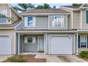 Townhome showing siding, white trim, and attached garage at 601 Buckthorn Cir, Summerville, SC 29483