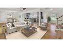 Bright open-concept living room with hardwood floors flowing into a modern kitchen at 703 Canary Dr, Charleston, SC 29414