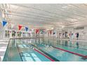Bright indoor pool with lap lanes, large windows, and festive decorations for a fun atmosphere at 729 Blue Iris Way, Summerville, SC 29486