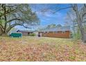Expansive backyard featuring mature trees, a storage shed, and ample space for outdoor activities at 746 Cartwright Dr, Charleston, SC 29414