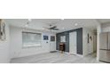 Well-lit living room with light gray walls, modern ceiling fan, and large window at 746 Cartwright Dr, Charleston, SC 29414