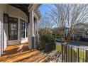 Charming covered porch with wooden floors, white columns, and black metal railings at 772 Post Oak Dr, Mount Pleasant, SC 29464