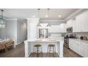 Modern kitchen features stainless steel appliances, white cabinets, and a quartz countertop island at 780 Clay Field Trl, Summerville, SC 29485