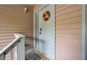 Close-up of the front door with a welcome mat and a decorative wreath at 7940 Parklane Ct # F, North Charleston, SC 29418