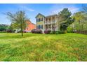 Lovely two-story home with a double porch and vibrant green lawn, showcasing curb appeal at 835 Hale St, Charleston, SC 29412
