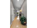 Bright hallway featuring wood floors, neutral walls, and decorative accents, leading to the living area at 9411 Harroway Rd, Summerville, SC 29485