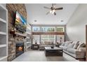 Cozy living room with stone fireplace, built-in shelves, and ample natural light at 9411 Harroway Rd, Summerville, SC 29485