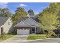 Charming brick home with a well-manicured lawn, two-car garage, and lush trees at 102 Brutus Ln, Summerville, SC 29485