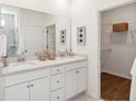 Elegant bathroom with dual sinks, quartz countertops, and a spacious walk-in closet at 1020 Sagegrass St, Summerville, SC 29485