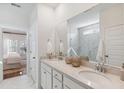 Bright bathroom featuring double sinks, quartz countertops, and a luxurious walk-in shower at 1020 Sagegrass St, Summerville, SC 29485
