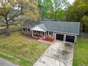 A birds eye view of a traditional brick home featuring an attached two-car garage and a spacious front yard at 103 Beverly Dr, Ladson, SC 29456