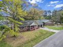 Brick home featuring an attached two-car garage, brick porch, and spacious front yard at 103 Beverly Dr, Ladson, SC 29456