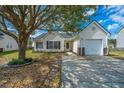 Beautifully maintained single-story home with attached garage, mature tree, and manicured landscaping at 104 Cranston Ln, Summerville, SC 29483