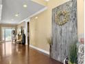Spacious foyer with wood floors, decorative wall art, and view of the living area at 113 Blackwater Way, Moncks Corner, SC 29461