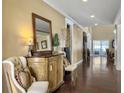 Inviting hallway with elegant decor and polished wood floors, leading to the main living areas at 113 Blackwater Way, Moncks Corner, SC 29461