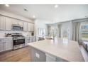 Modern kitchen with stainless steel appliances, sleek countertops, and a large island with a sink at 1132 Mossy Rock Dr, Summerville, SC 29485