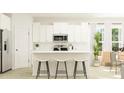 Modern kitchen featuring white cabinetry, stainless steel appliances, and a center island with seating at 1151 Darling St, Summerville, SC 29485