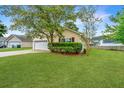 Charming single-story home with lush green lawn and mature landscaping at 1312 Belle Grove Cir, Hanahan, SC 29410