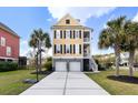 Attractive two-story yellow home with a two-car garage and a basketball hoop, set in a well-kept lawn at 138 Sandshell Dr, Charleston, SC 29492