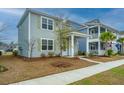 Street view of a well kept gray two story home with a inviting covered front porch and clean sidewalk at 143 Brant Dr, Summerville, SC 29483