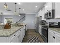 Bright kitchen boasts granite countertops, stainless appliances, and ample cabinet space at 1586 Innkeeper Ln, Johns Island, SC 29455