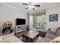Living room with a TV, a gray sofa, an area rug and sliding doors to a balcony at 1600 Long Grove Dr # 1226, Mount Pleasant, SC 29464