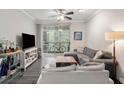 Living room with a TV, sofas, a bar cart, an area rug and sliding doors to a balcony at 1600 Long Grove Dr # 1226, Mount Pleasant, SC 29464