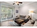 Cozy living room featuring a comfortable gray sectional and sliding glass doors to the patio at 1600 Long Grove Dr # 1226, Mount Pleasant, SC 29464
