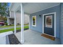View of the front porch showing a welcome mat and a gray front door at 1725 W Avalon Cir, Charleston, SC 29407